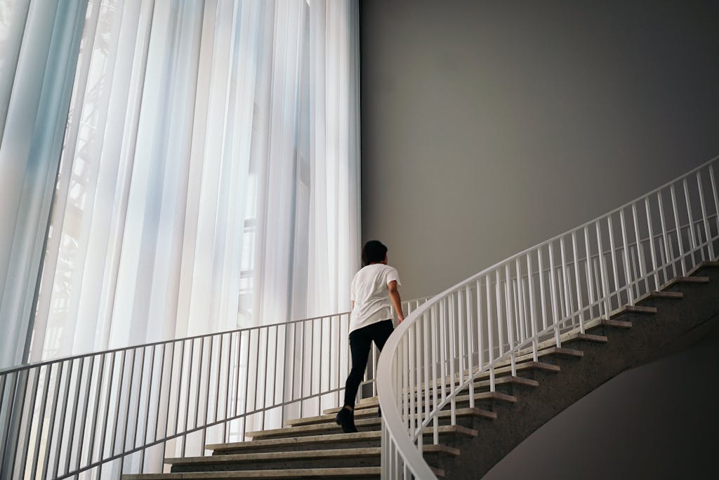 Person Walking On Stairs Inside Building